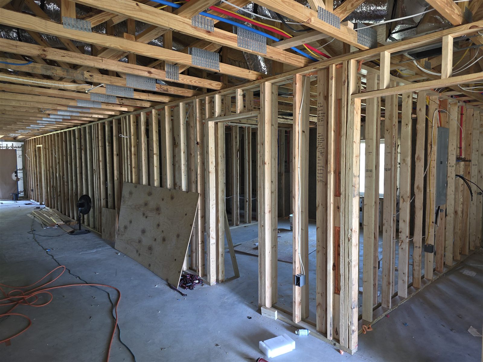 Open wall framing showing wiring and plumbing before drywall installation, Tampa Bay, FL